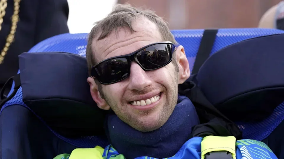 Rob Burrow wears black sunglasses and smiles